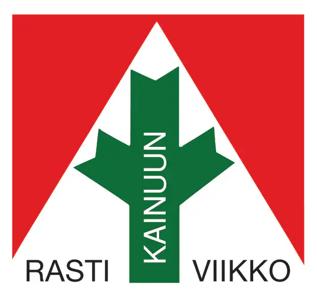 Logo, jossa on punainen kolmio ja vihreä nuoli, pystysuunnassa sana "KAINUUN" ja alakulmissa mustalla teksti "RASTI VIIKKO".